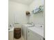 Functional laundry room with white appliances and storage shelves at 310 Silent Bluff Dr, Summerville, SC 29486