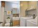 Cozy bathroom with vanity, shelves, washing machine, dryer and toilet at 311 Macgregor Dr, Summerville, SC 29486