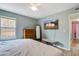 Bedroom features a ceiling fan, dresser, mirror, television and bench at 311 Macgregor Dr, Summerville, SC 29486