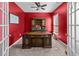 Home office with a large wooden desk, red walls, and natural light streaming through the window at 317 Bountiful Dr, Moncks Corner, SC 29461