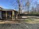A large, unfenced backyard with a screened-in porch attached to the house offers outdoor living and relaxation at 338 Holly Ave, Goose Creek, SC 29445