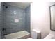 Updated bathroom featuring stylish blue tile, bathtub, and modern fixtures at 338 Holly Ave, Goose Creek, SC 29445
