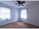 Cozy bedroom featuring hardwood floors, ceiling fan, and bright windows at 338 Holly Ave, Goose Creek, SC 29445