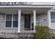 Inviting covered porch with white columns and brick accents, perfect for relaxing outdoors at 338 Holly Ave, Goose Creek, SC 29445