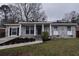 Charming single-story home with a well-manicured front yard and a classic brick facade at 338 Holly Ave, Goose Creek, SC 29445