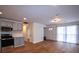Open living space featuring wood floors, modern kitchen, and natural light at 338 Holly Ave, Goose Creek, SC 29445
