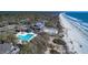 Aerial view of beachfront home and community, showing beach access and multiple swimming pools at 385 Green Winged Teal Rd, Kiawah Island, SC 29455
