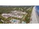 Expansive aerial view showcasing a luxury resort nestled near the beach, lush golf course, and a stunning coastline at 385 Green Winged Teal Rd, Kiawah Island, SC 29455
