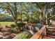 Inviting back deck with lovely outdoor seating overlooks the backyard and surrounding mature trees and greenery at 385 Green Winged Teal Rd, Kiawah Island, SC 29455
