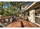 Backyard deck area with outdoor furniture, trees, and a view of the home at 385 Green Winged Teal Rd, Kiawah Island, SC 29455