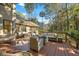 Backyard deck with multiple seating areas, a grill, and an outdoor dining table at 385 Green Winged Teal Rd, Kiawah Island, SC 29455
