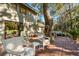 Backyard deck features outdoor seating, a grill, and views of the wooded area at 385 Green Winged Teal Rd, Kiawah Island, SC 29455