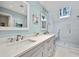 Bright bathroom featuring double sinks, a skylight, and a glass shower at 385 Green Winged Teal Rd, Kiawah Island, SC 29455