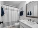 Bathroom featuring a shower with white and gray curtain and a sink with a large mirror above at 385 Green Winged Teal Rd, Kiawah Island, SC 29455