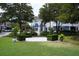 Inviting courtyard featuring neatly trimmed hedge benches, lush landscaping, and charming storefronts at 385 Green Winged Teal Rd, Kiawah Island, SC 29455