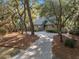 Landscaped single-Gathering home featuring a private driveway surrounded by mature trees at 385 Green Winged Teal Rd, Kiawah Island, SC 29455