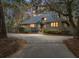 Charming single-Gathering home featuring a private driveway and an inviting, landscaped front yard at 385 Green Winged Teal Rd, Kiawah Island, SC 29455