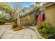 A quaint entrance to the home with professional landscaping and an American flag in the yard at 385 Green Winged Teal Rd, Kiawah Island, SC 29455