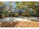 Charming front exterior with a well-manicured lawn, mature trees, and a welcoming entrance at 385 Green Winged Teal Rd, Kiawah Island, SC 29455