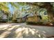 Charming front exterior with a well-manicured lawn, mature trees, and a welcoming entrance at 385 Green Winged Teal Rd, Kiawah Island, SC 29455