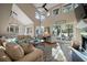 Bright living room boasts soaring ceilings, a ceiling fan, fireplace, and sliding glass doors to the outside at 385 Green Winged Teal Rd, Kiawah Island, SC 29455