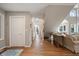 Open-concept living space with hardwood floors leading to staircase and sunlit living room at 385 Green Winged Teal Rd, Kiawah Island, SC 29455