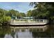 Outdoor seating area overlooking the pond offers a peaceful spot to relax and enjoy the surrounding landscape at 385 Green Winged Teal Rd, Kiawah Island, SC 29455