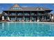 Large pool at this property, surrounded by lounge chairs, tables, umbrellas and a bar at 385 Green Winged Teal Rd, Kiawah Island, SC 29455