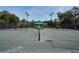 Well-maintained tennis courts with professional nets, lighting, and shaded benches for players and spectators at 385 Green Winged Teal Rd, Kiawah Island, SC 29455