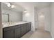 Well-lit bathroom with a double sink vanity, granite countertops, and modern finishes at 404 Duskywing Dr, Goose Creek, SC 29445
