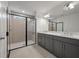 Modern bathroom featuring tiled shower with glass door, double vanity with granite countertops, and modern fixtures at 404 Duskywing Dr, Goose Creek, SC 29445