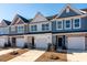 Attractive townhome exteriors feature attached garages, manicured landscaping, and eye-catching color palettes at 404 Duskywing Dr, Goose Creek, SC 29445