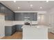 Contemporary kitchen boasting ample cabinet space, a center island with granite countertop, and stainless steel appliances at 404 Duskywing Dr, Goose Creek, SC 29445