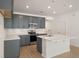 Well-lit kitchen featuring stainless steel appliances, granite countertops and grey cabinets, perfect for modern living at 404 Duskywing Dr, Goose Creek, SC 29445