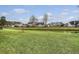 View of a lush green backyard and pond, complemented by well-maintained lawns and the neighborhood homes at 412 Hainesworth Dr, Charleston, SC 29414