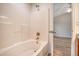 Bathroom showcasing a tub with shower, white tile surround, and access to the bedroom at 412 Hainesworth Dr, Charleston, SC 29414
