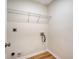 Bright laundry room with wire shelving, light wood floors and neutral paint at 412 Hainesworth Dr, Charleston, SC 29414