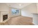 Bright living room with a fireplace, large window overlooking a pond, and hardwood floors at 412 Hainesworth Dr, Charleston, SC 29414