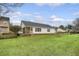 View of a home's backyard, with a screened porch and well-maintained lawn, offering a relaxing outdoor space at 412 Hainesworth Dr, Charleston, SC 29414