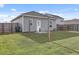 Backyard view of the house featuring green grass and grey siding and fenced perimeter at 414 Pender Woods Dr, Summerville, SC 29486