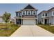 Charming two-story home with navy siding, white trim, and a spacious two-car garage at 418 Grove End Rd, Moncks Corner, SC 29461