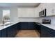 Modern kitchen with two-tone cabinets, stainless steel appliances, and marble countertops at 418 Grove End Rd, Moncks Corner, SC 29461