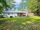 Spacious backyard featuring a screened-in porch and a metal roof at 422 Academy Rd, Walterboro, SC 29488
