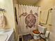 Classic full bath featuring a toilet, vanity, and shower with turtle decor at 422 Academy Rd, Walterboro, SC 29488