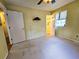 A spacious bedroom with a ceiling fan, closet, and a door leading to the ensuite bathroom at 422 Academy Rd, Walterboro, SC 29488