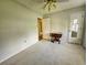 This bedroom is complete with carpet and a table with an open door to the hall at 422 Academy Rd, Walterboro, SC 29488