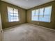 Empty carpeted bedroom with neutral walls and a double window for natural light at 422 Academy Rd, Walterboro, SC 29488