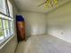 A quaint bedroom features carpet and a big window with a dresser next to it at 422 Academy Rd, Walterboro, SC 29488