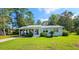 Cozy single-story home with a carport, complemented by a lush green lawn and mature trees at 422 Academy Rd, Walterboro, SC 29488