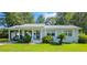 Charming single-story home with a metal roof, covered carport, and beautifully landscaped front yard at 422 Academy Rd, Walterboro, SC 29488